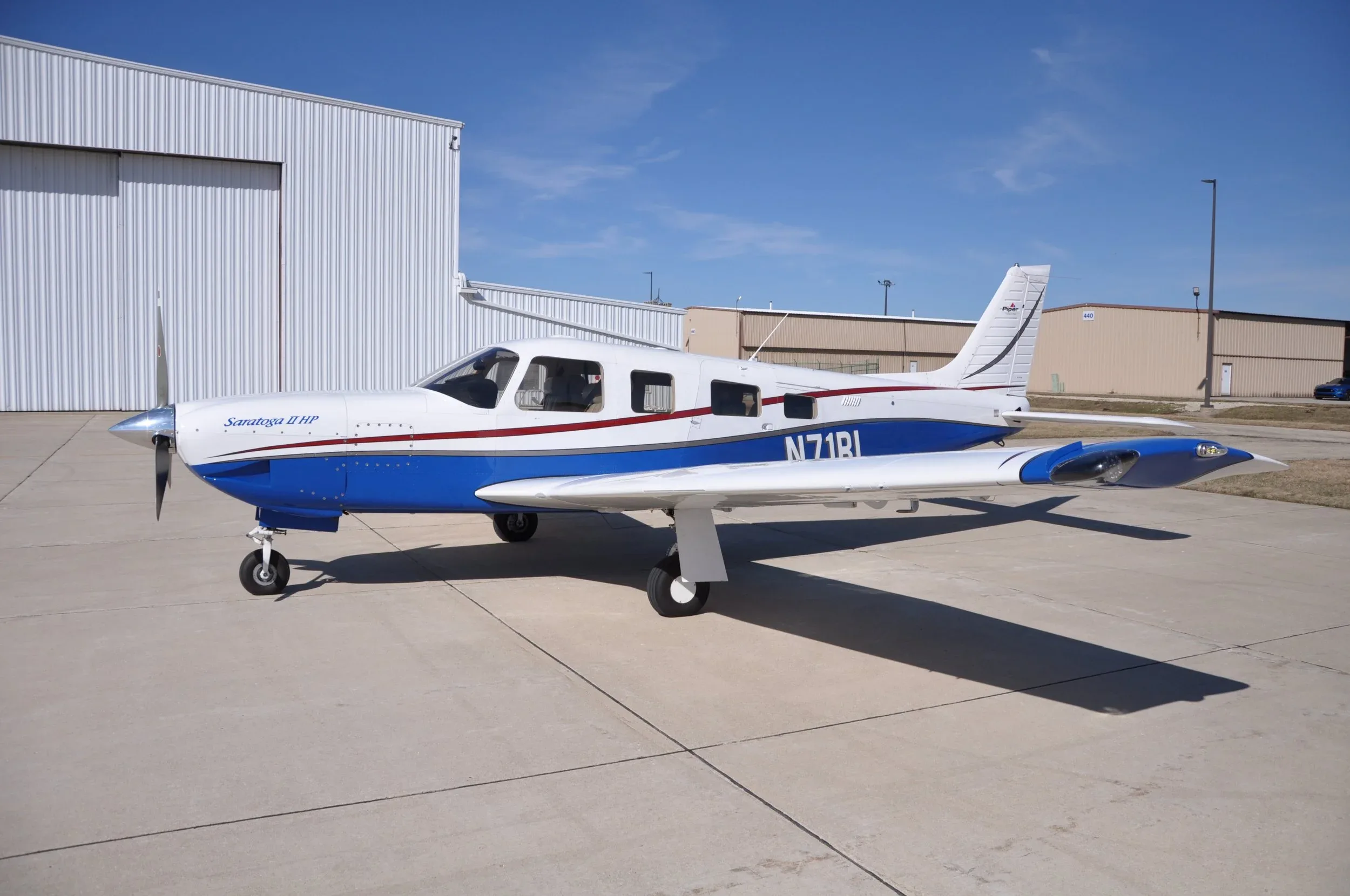 A Saratoga II HP aircraft with registration N71RL is parked on the tarmac.