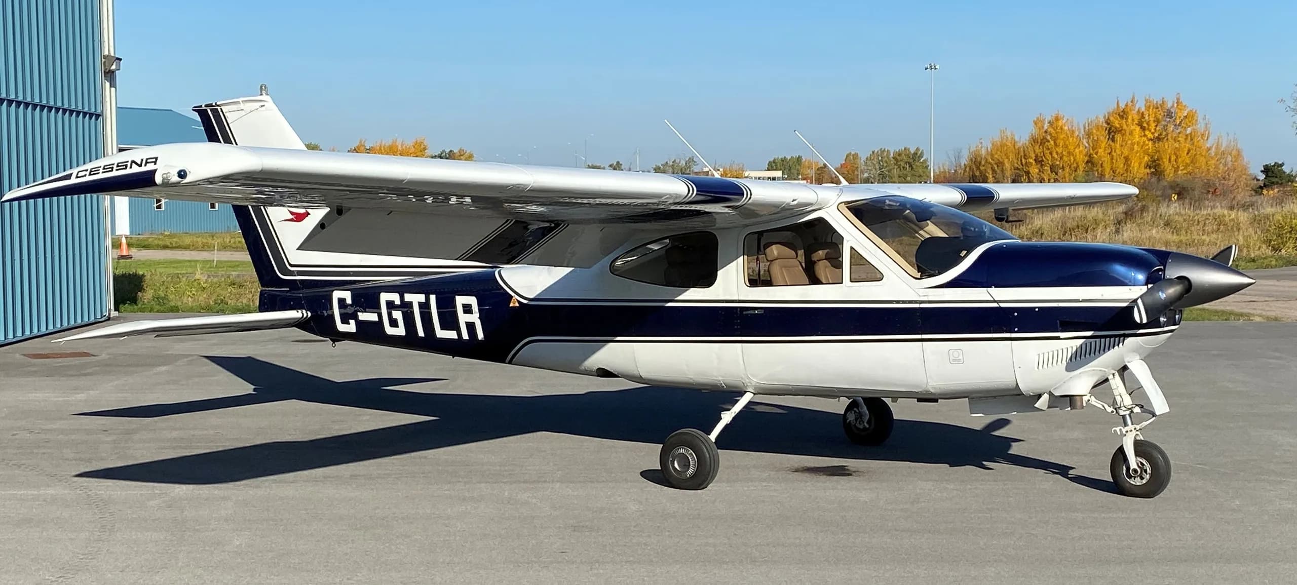 Cessna C-GTLR parked outside a hangar on a sunny day.