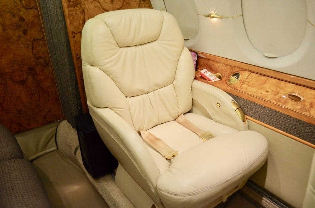 Interior of the aircraft with a leather seat and wooden trim.