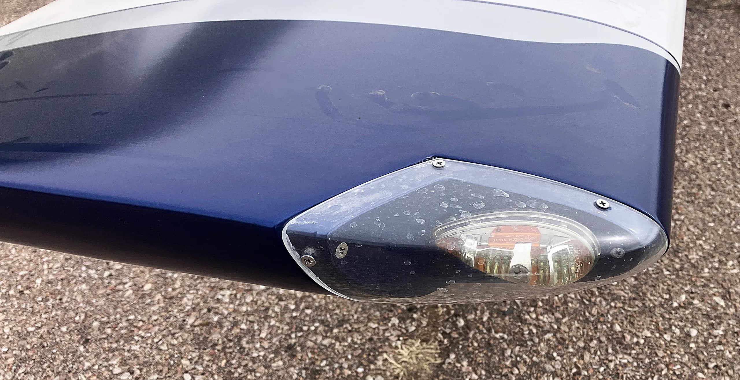 A close-up view of the blue wingtip and navigation light of the Glasair Sportsman aircraft.