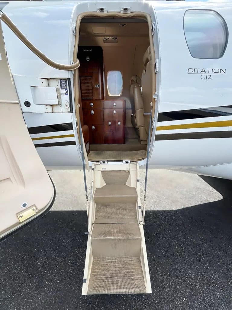View of the entry stairs and interior cabinetry of a Citation CJ2 aircraft.