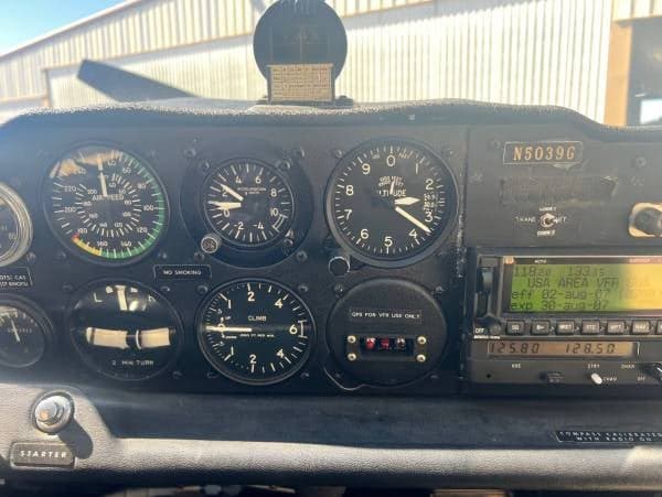 A view of the aircraft's instrument panel, featuring various gauges, a radio stack, and the registration N5039G.
