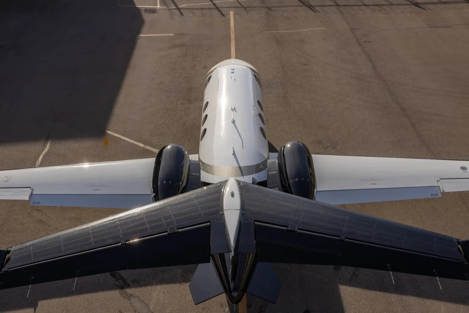 Top-down view of a Cessna Citation Mustang aircraft on the tarmac.