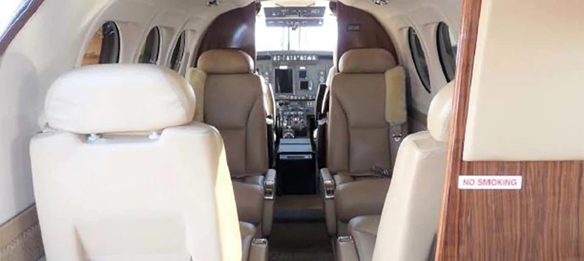 View of the cabin seats and cockpit of a Beechcraft King Air.