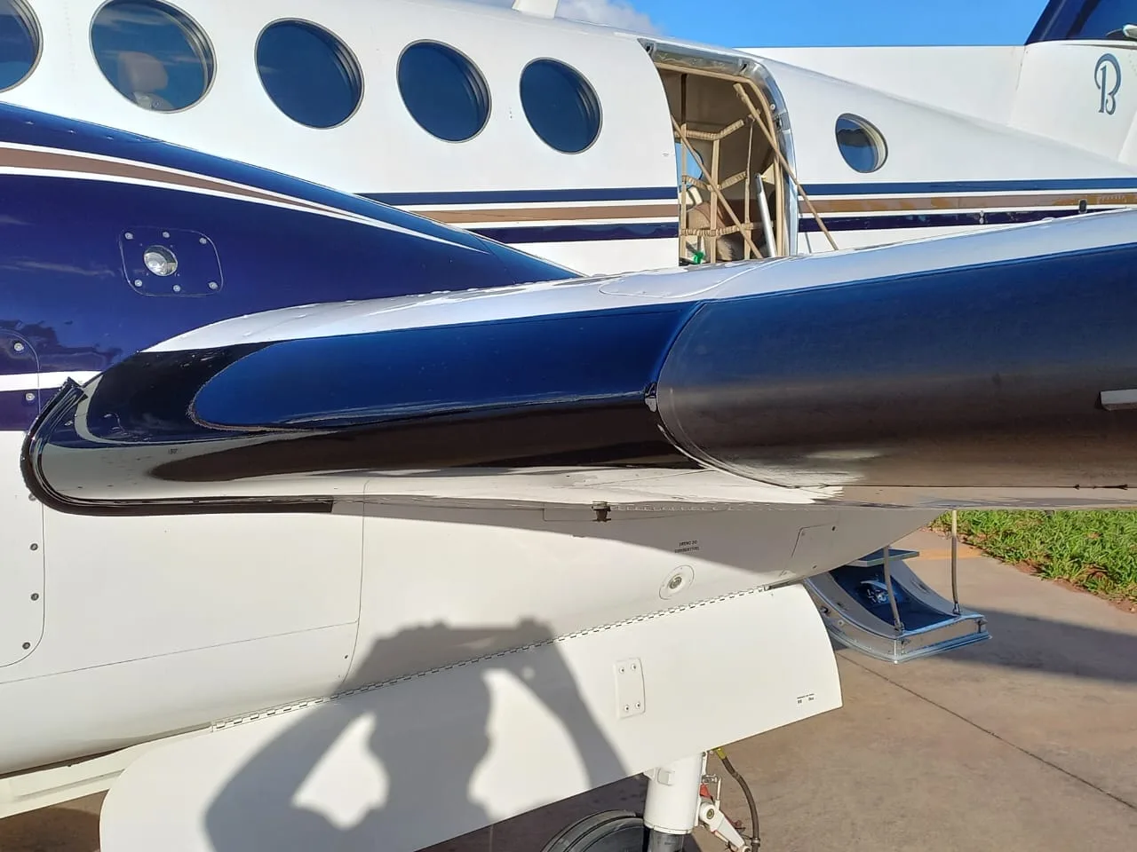Close up of the wing and fuselage of a Beechcraft King Air 200.