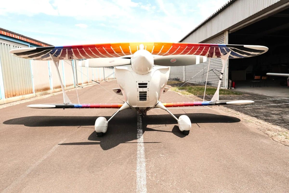 Front view of the Christen Eagle II biplane with colorful stripes on the wings.