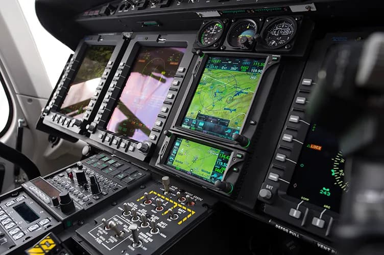 A close-up of a helicopter's digital instrument panel.