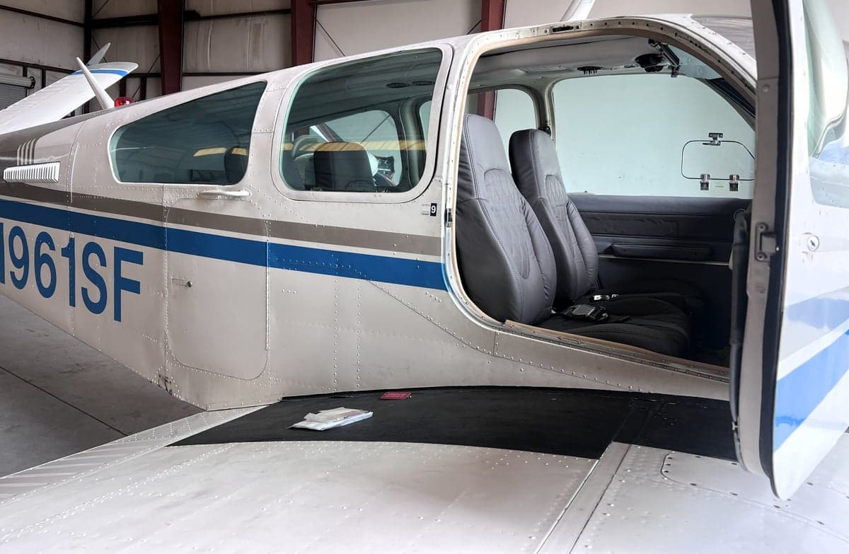 Close-up of the aircraft's exterior showing the registration N961SF and the open door revealing the interior seats.