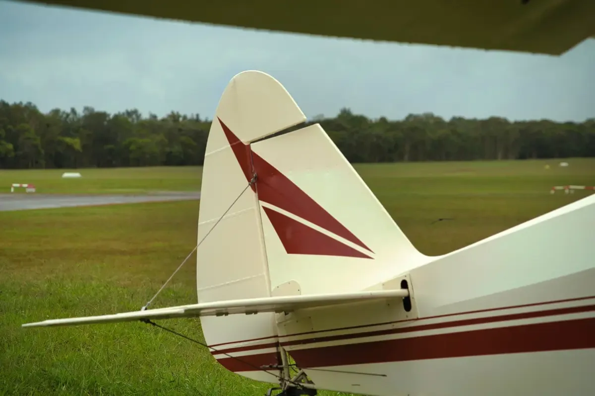 A close-up view of the cream and maroon tail section of the VH-TSY aircraft.