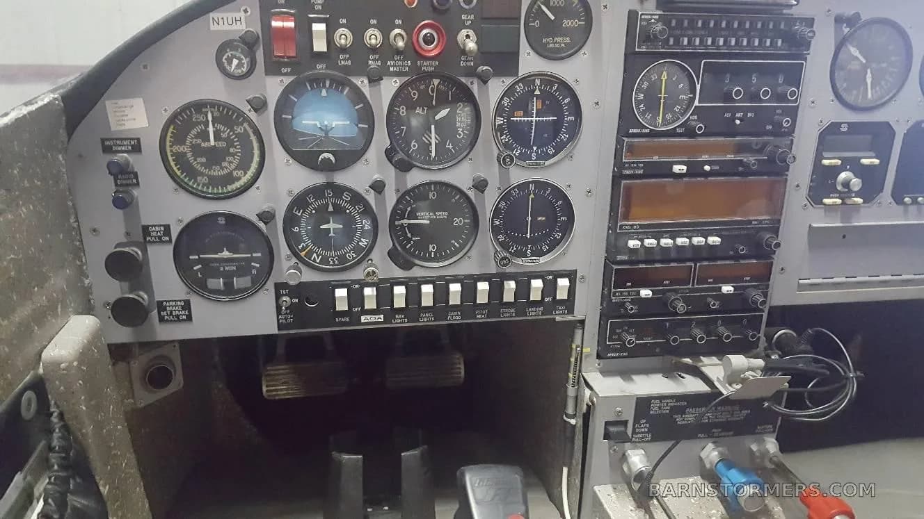 A close-up view of an aircraft's instrument panel, featuring analog gauges and avionics.