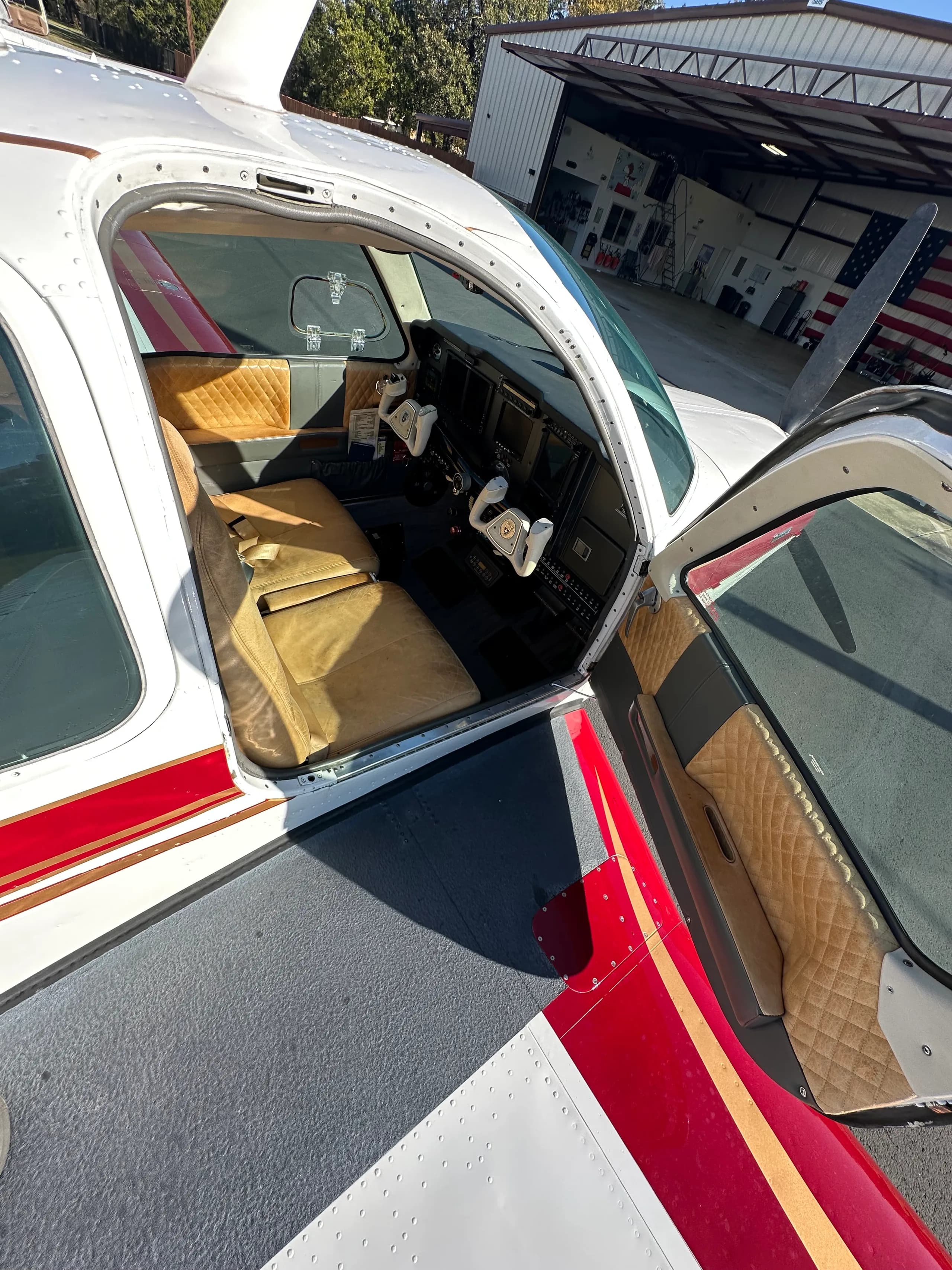 The interior of the aircraft is visible through the open door, showing the seats and cockpit.