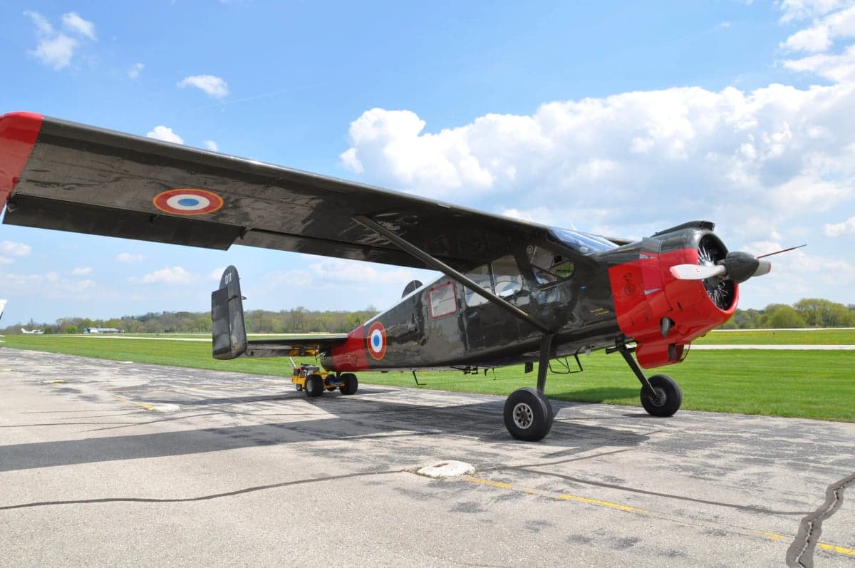 A Morane-Saulnier MS.505 Criquet aircraft is parked on the tarmac.