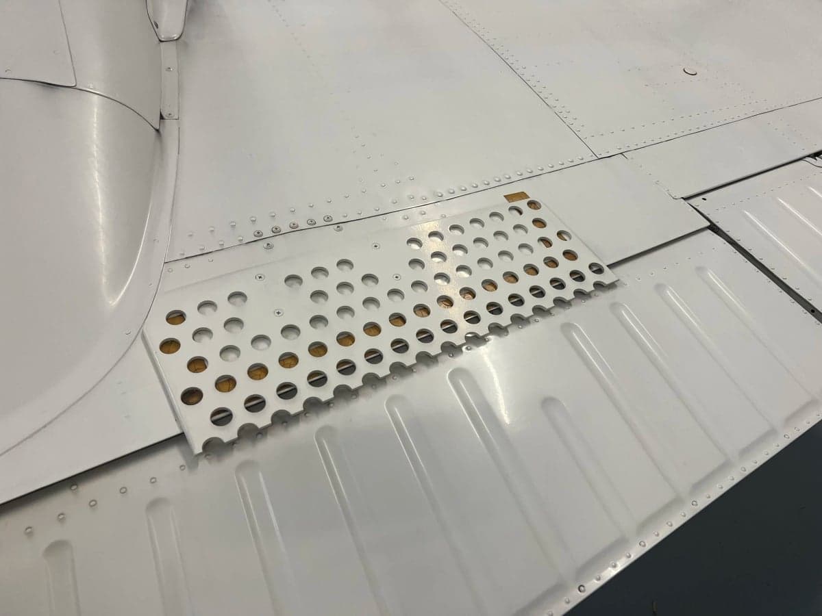 Close-up of the wing of the aircraft showing the surface details and construction.