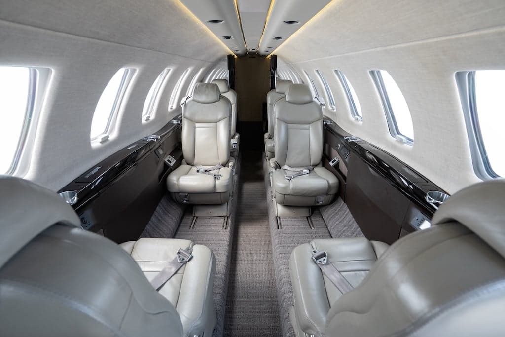 View of the aircraft's interior cabin with leather seats.