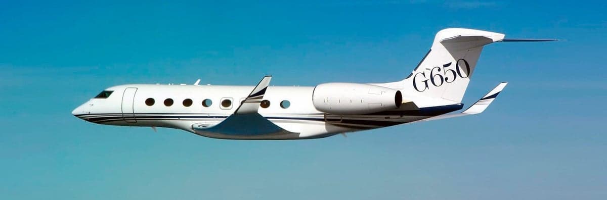 A white Gulfstream G650 is flying in the sky.