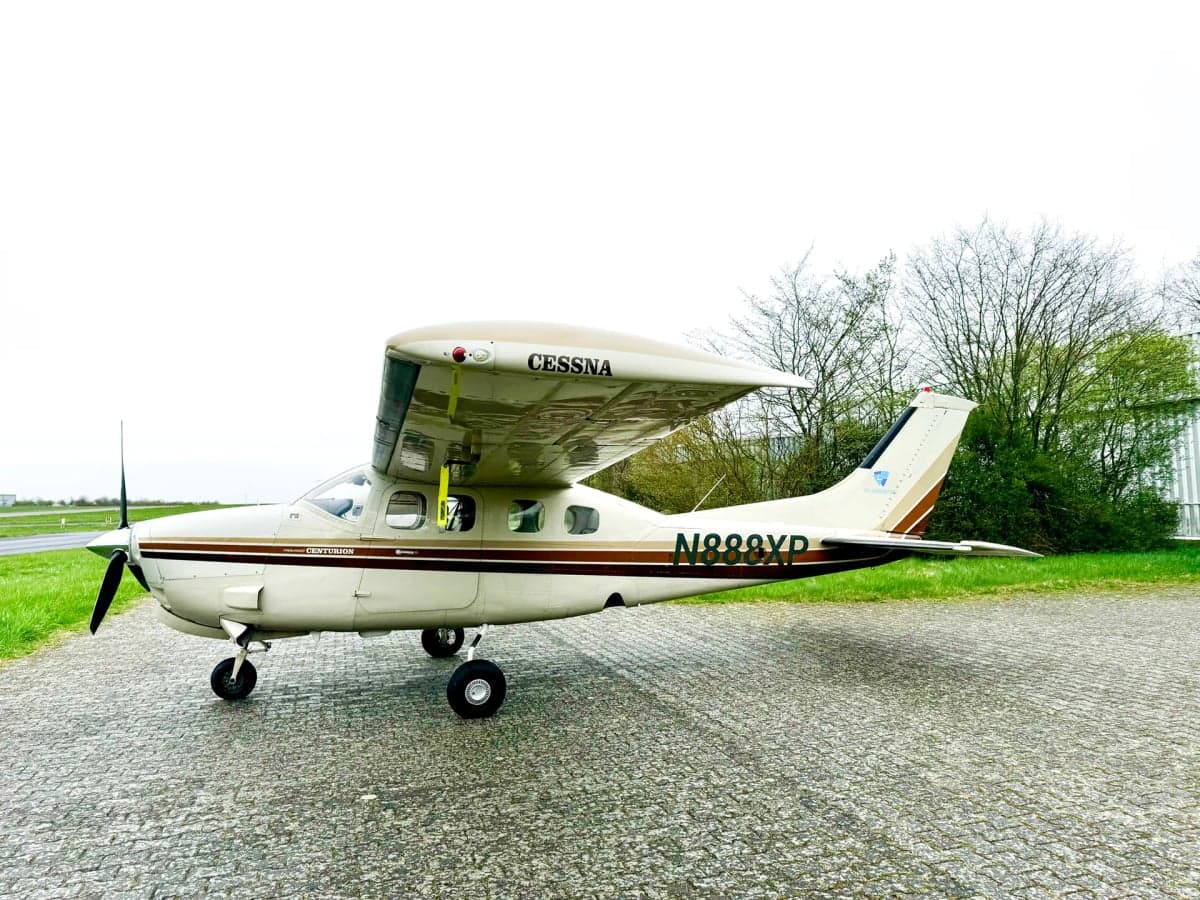Cessna Centurion with a white and brown paint scheme on the tarmac.