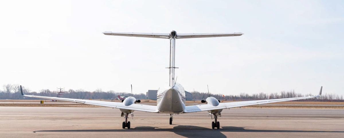 Rear view of a King Air aircraft parked on the tarmac.