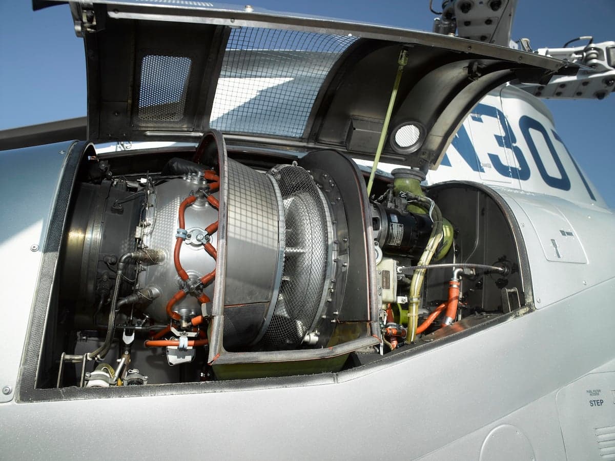 Close-up of the helicopter engine with the access panel open.