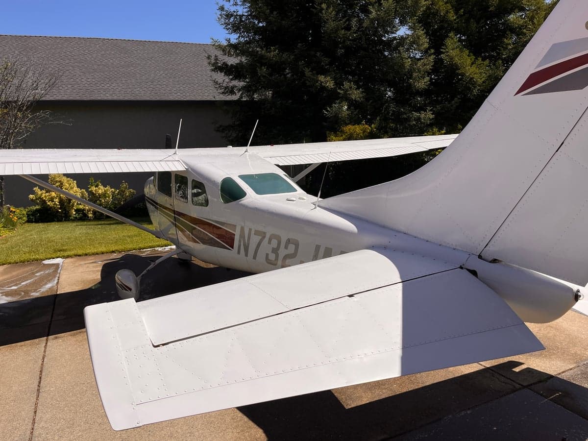 A rear quarter view of the Cessna Skymaster N732JM on the ground.
