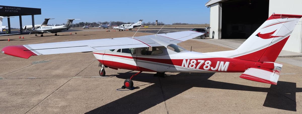 Side view of Cessna N878JM parked on the tarmac.