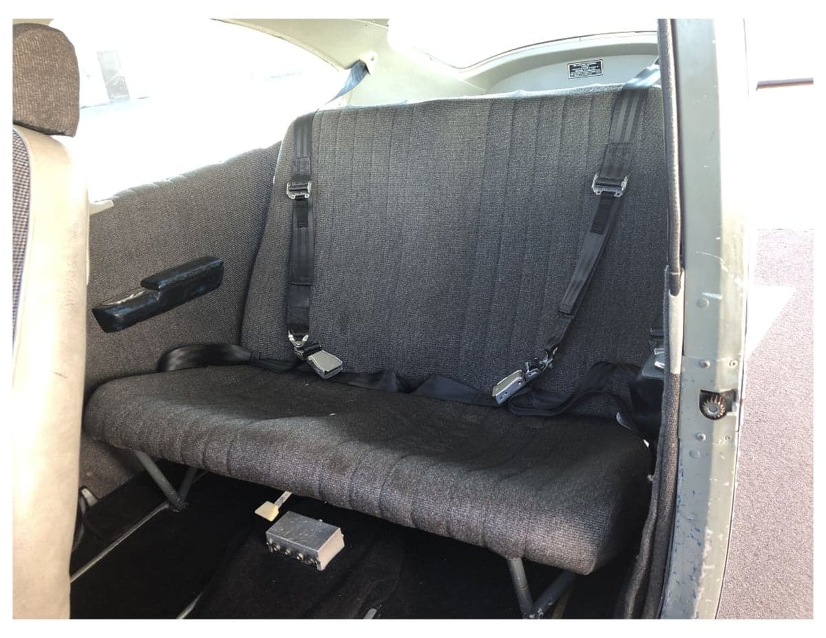 View of the rear bench seat inside the aircraft cabin.