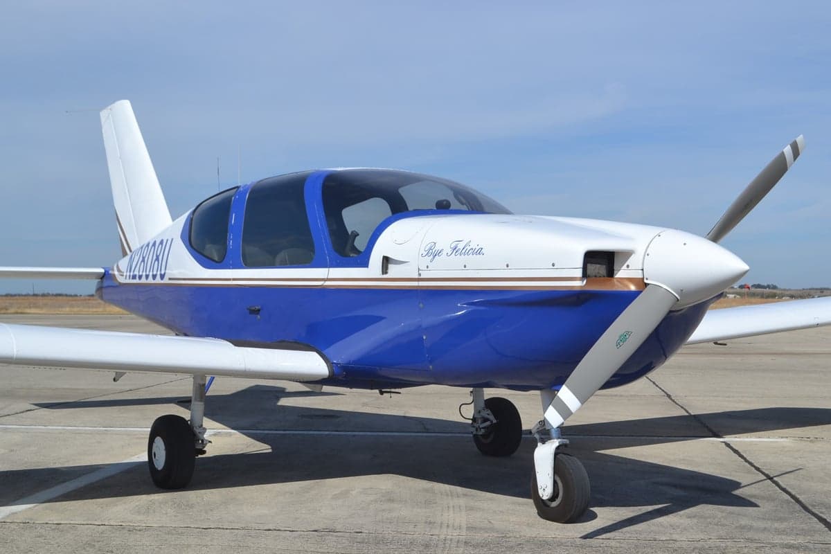 A blue and white single-engine aircraft, N2808U, is parked on the tarmac.