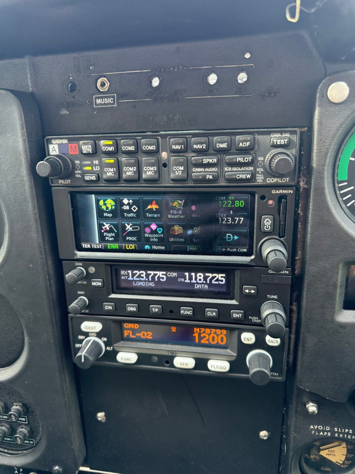 Avionics stack with Garmin radio and transponder showing tail number N78799.