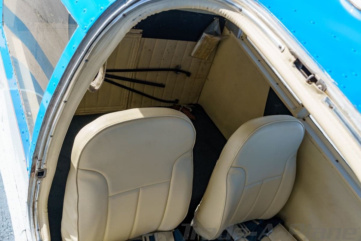 An overhead view of the light-colored interior seats of the N8718N aircraft cabin.