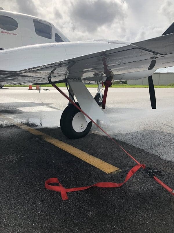 Close-up of the landing gear and wing of the N513JN aircraft.