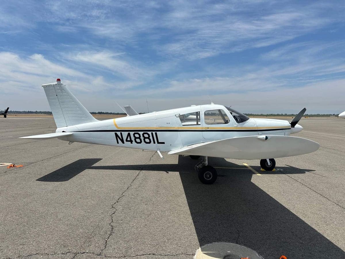 A Piper PA-28-140 Cherokee with tail number N4881L parked on the tarmac.