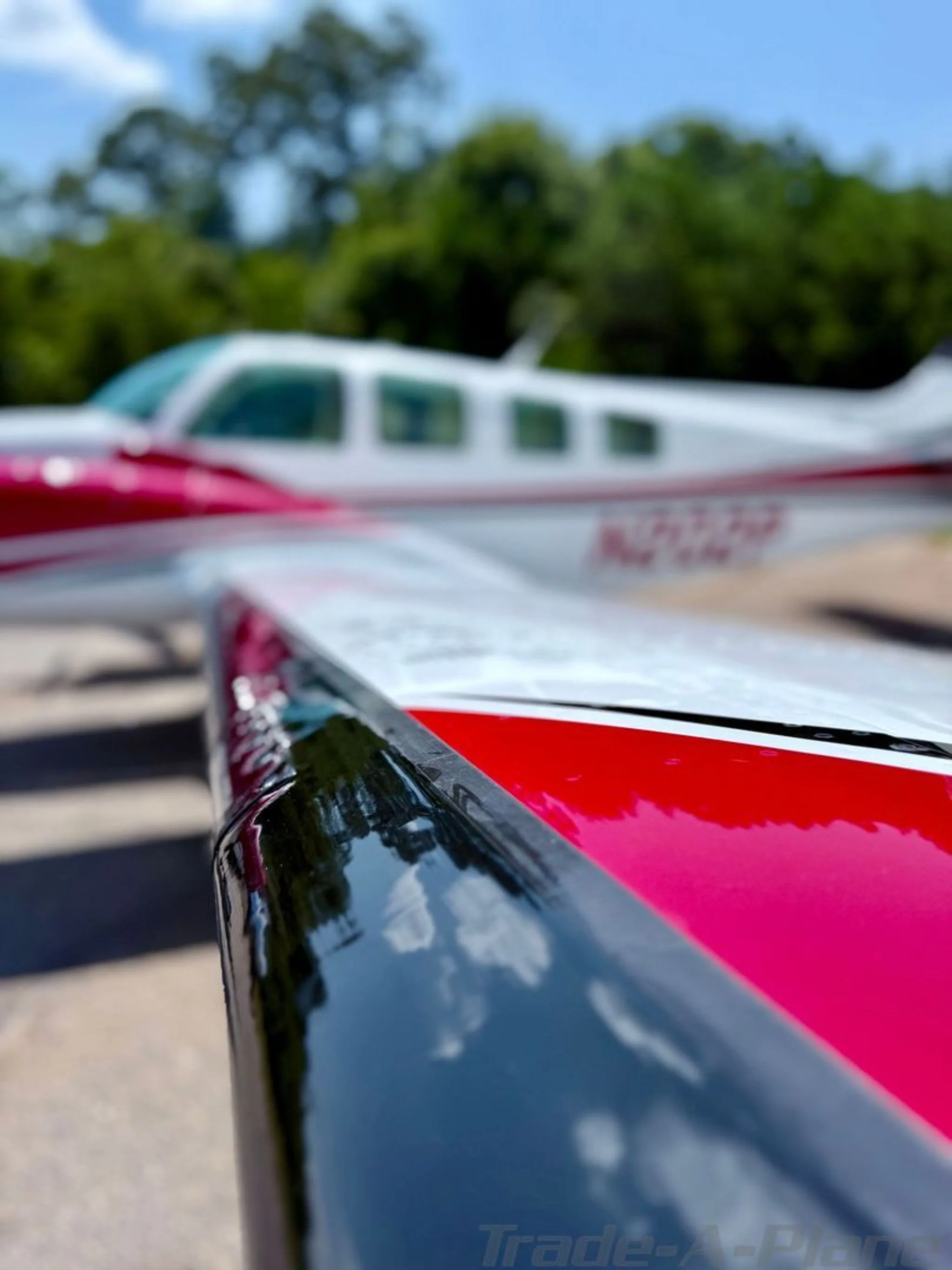 Close-up of the red and black leading edge of the wing of the Beechcraft Baron N202P.