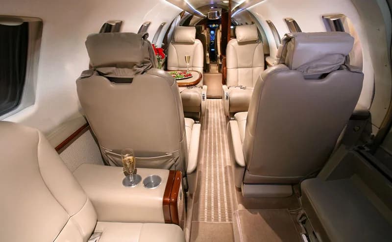 View of the aircraft's leather interior with seating and refreshments.