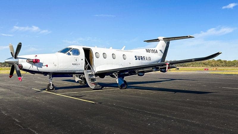 Pilatus PC-12 aircraft N819SA on the tarmac with the door open.