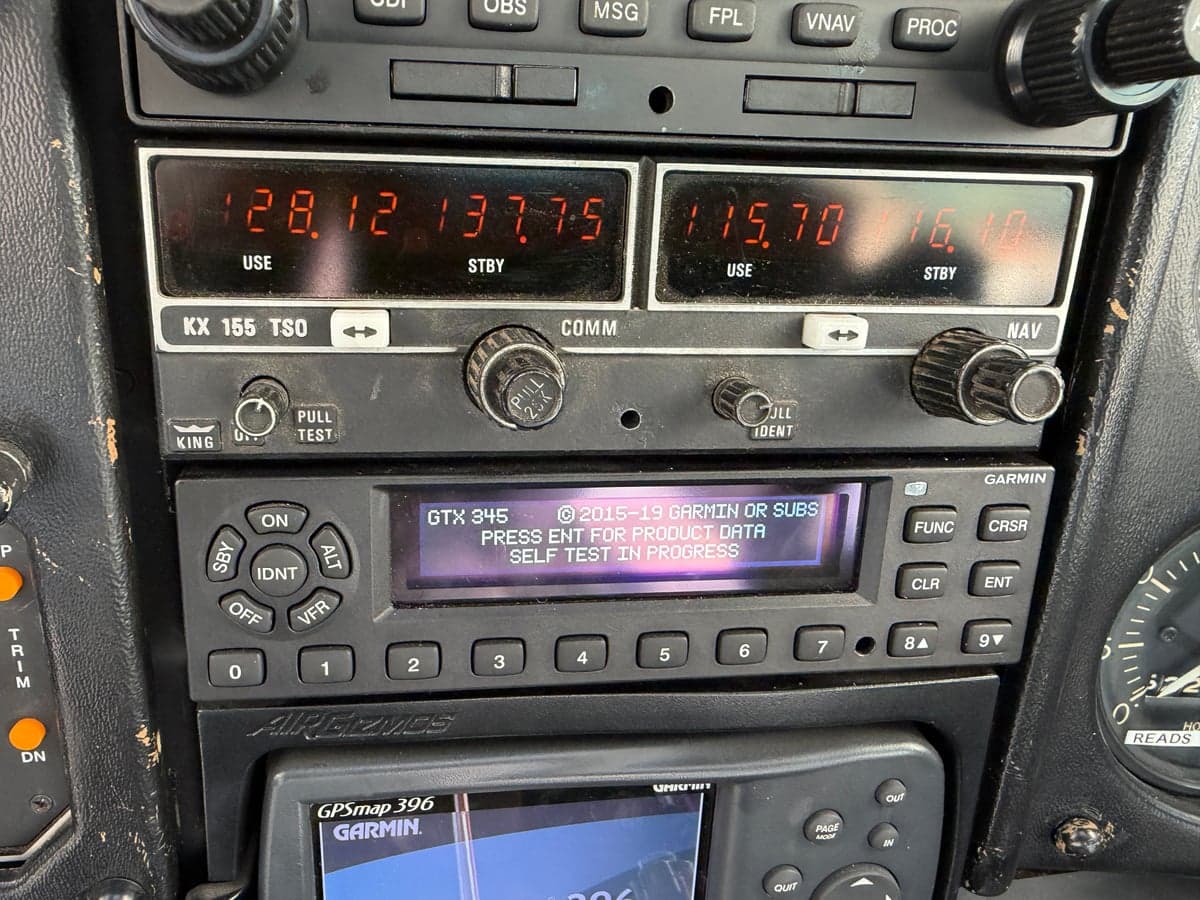 Close-up of the KX 155 TSO and GTX 345 avionics units in the aircraft's cockpit.