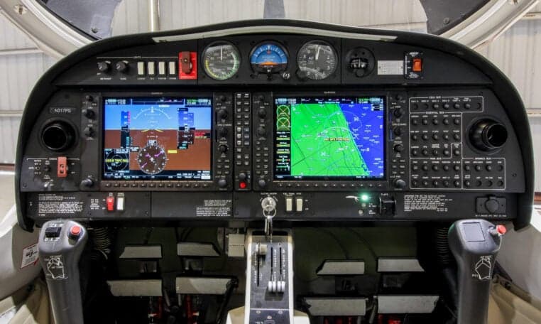 The cockpit of a Diamond DA40 aircraft features a modern glass panel.