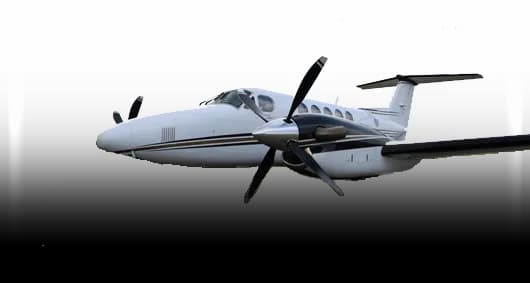 A white twin-engine turboprop aircraft with black engine nacelles and propellers, viewed from the front-right against a white background.
