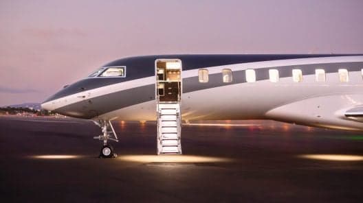Bombardier Challenger 350 with a white and blue paint scheme on the tarmac.