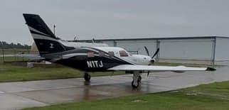 Rear-facing black leather seats in the cabin of the Pilatus PC-12.