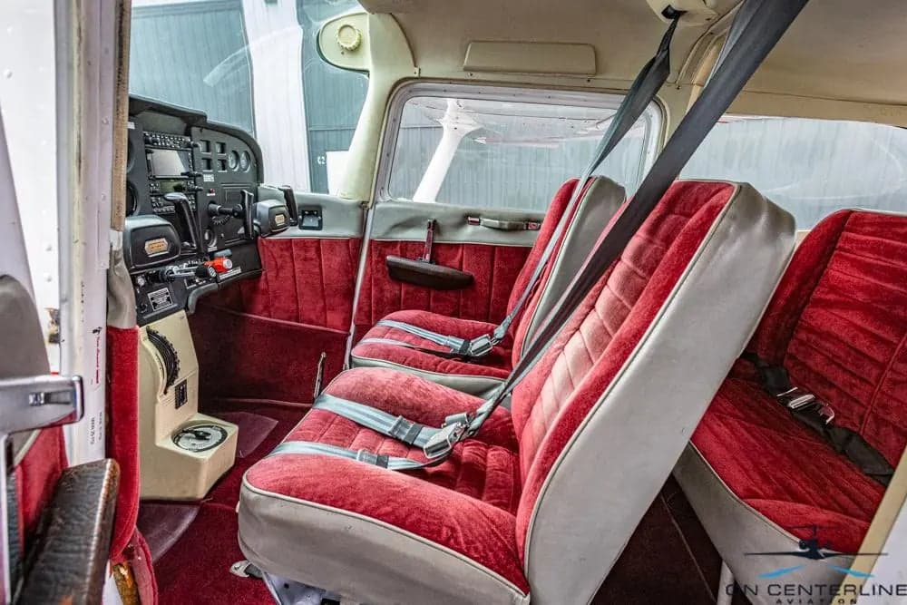 Interior view of the Cessna 172 Skyhawk cabin with red seats.