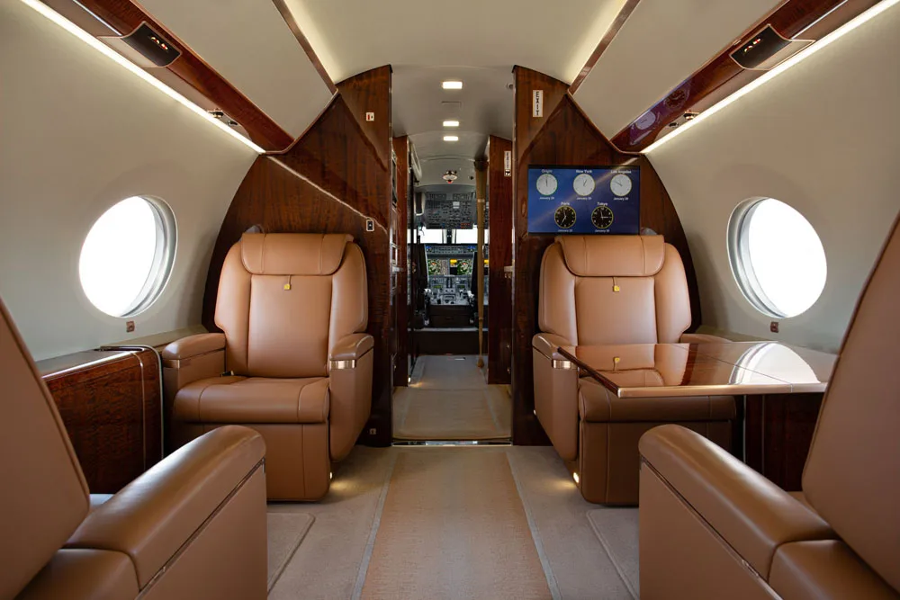 Forward cabin with leather seats and a bulkhead monitor.