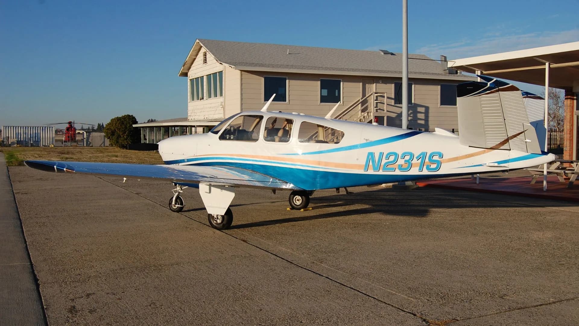 Side view of the N231S aircraft parked on the tarmac.