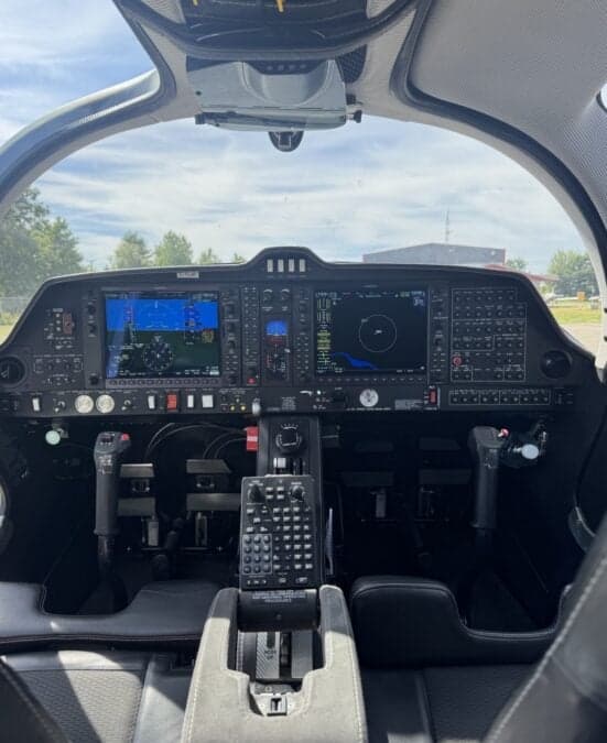 View of the Diamond DA62 cockpit instrument panel and seats.