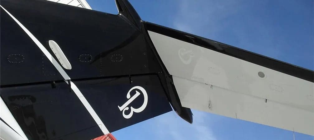 Close-up of the tail of a King Air aircraft with a distinctive logo.