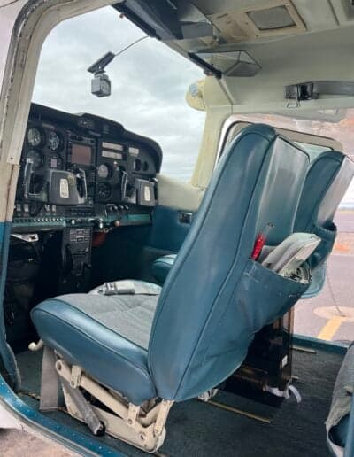 Interior view of the aircraft showing the cockpit and front seats.