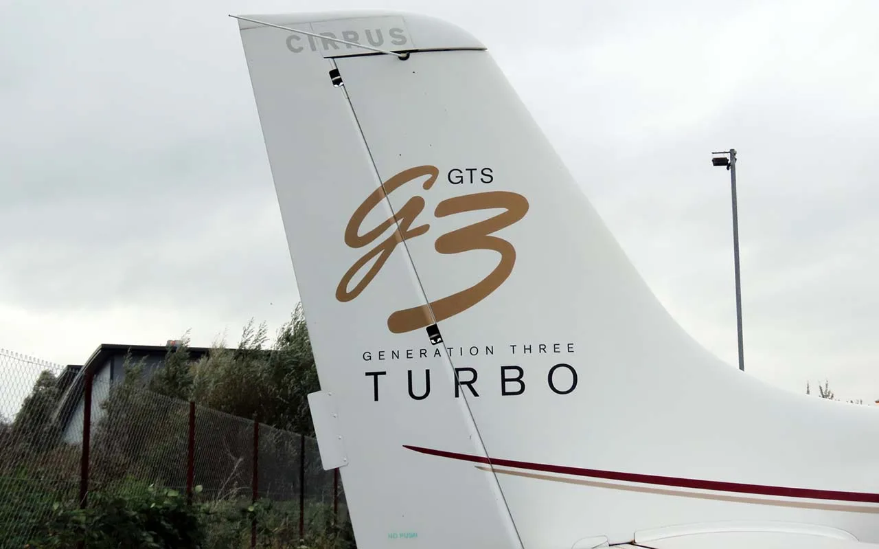 A close-up of the white tail of a Cirrus SR22T, showing the "GTS G3 Generation Three Turbo" logo.