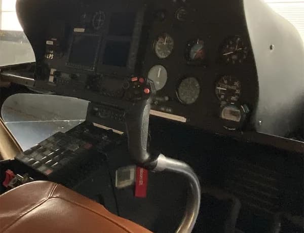 Close-up of the helicopter's instrument panel and control stick.