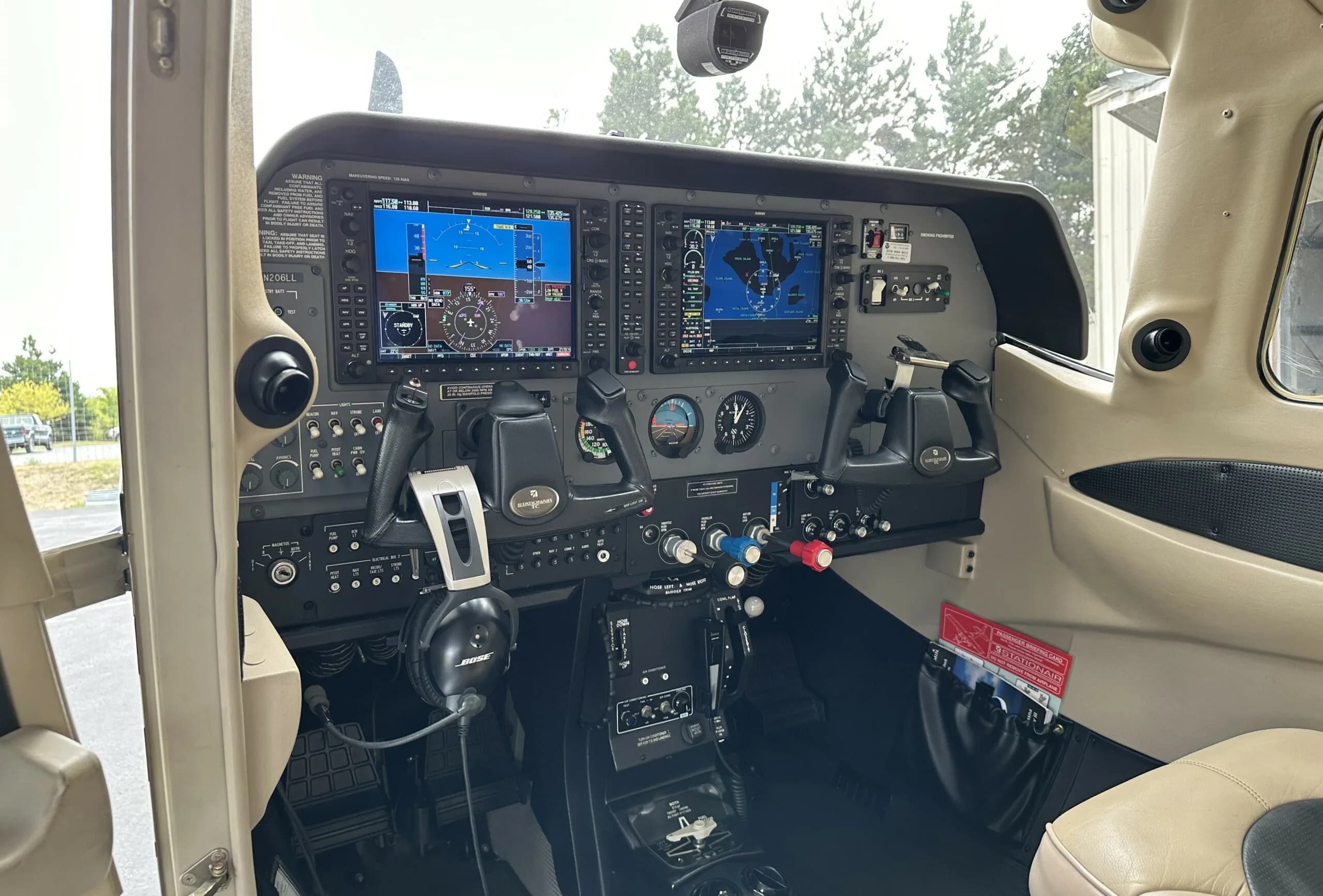 Cockpit view of the Cessna 206 Stationair with modern avionics.