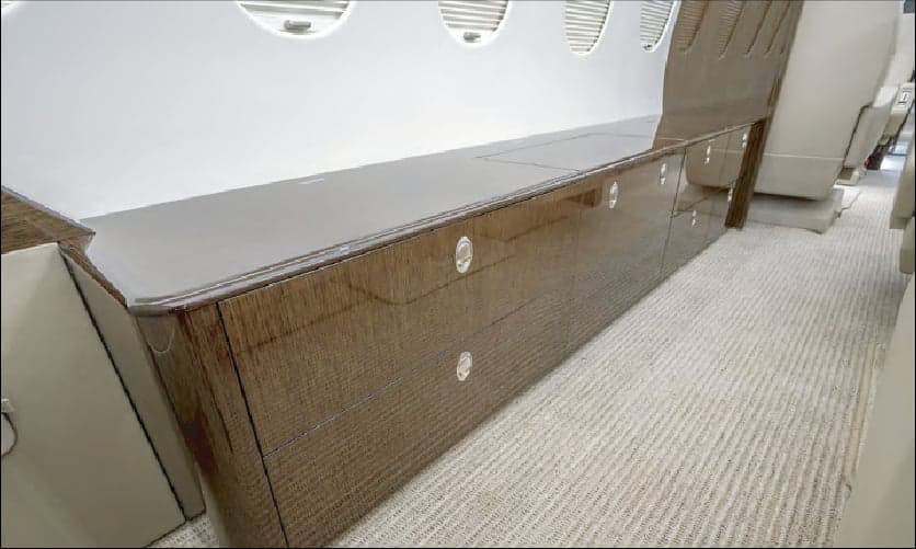 Close up of the wood cabinets in the interior cabin of a jet.