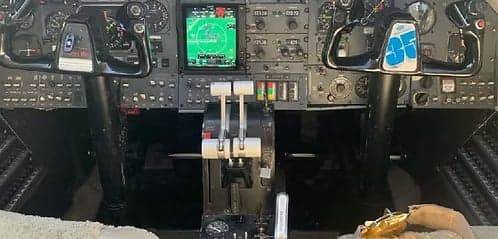 The aircraft cockpit featuring the instrument panel and controls.