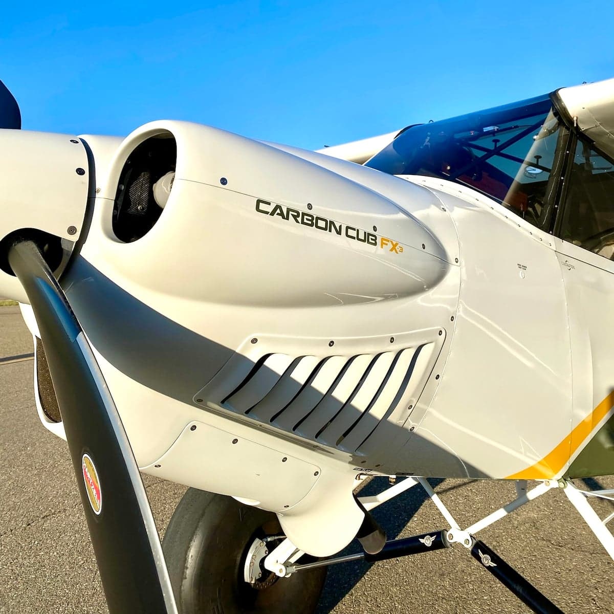 Close up of the engine and propeller of a Carbon Cub FX-3 aircraft.